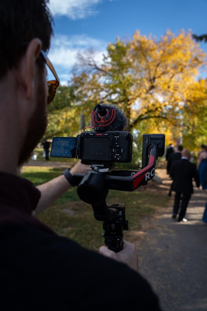 Mastering the First Impression: Your intriguing post title goes here A videographer captures an autumn wedding scene with vibrant foliage in Calgary, Canada.